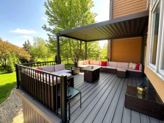 Incredible elevated deck in Cumming, GA, with pergola and ground-level stone patio
